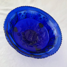 Load image into Gallery viewer, Gorgeous antique cobalt blue  &quot;Butterfly and Berries&quot; paneled bowl with three feet. Produced by the Fenton Art Glass, circa 1920s. The bowl panels have a lovely alternating pattern of raspberries on the vine and butterflies. The centre of the bowl has a butterfly surrounded by raspberries on the vine. A lovely decorative piece to use as a fruit bowl, catchall or decor piece.  In excellent condition, free from chips/cracks/wear.  Measures 9 1/4  x 3 3/4 inches
