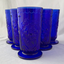 Load image into Gallery viewer, RARE FIND! Charming vintage cobalt blue Cherry 7-15 iced tea footed glass tumblers. Produced by the LG Wright Glass Company, USA, circa 1960s. The pattern consists of a trio of cherries surrounded by a wreath pf leaves bordered by a fluted design and a scalloped detail below the rim. In great vintage condition. One glass has a manufacturer&#39;s defect at the base, one glass has minor flea bites at the rim. The others are in excellent condition, free from chips/cracks.

