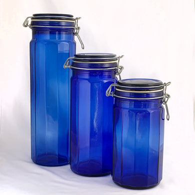 Vintage twelve panel cobalt blue glass apothecary storage jars with wire bail lids.  In excellent condition, free from chips/cracks.  Measuring:  3 7/8 x 13 inches  3 7/8 x 9 3/4 inches  3 7/8 x 8 inches