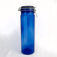 Load image into Gallery viewer, Vintage twelve panel cobalt blue glass apothecary storage jars with wire bail lids.  In excellent condition, free from chips/cracks.  Measuring:  3 7/8 x 13 inches  3 7/8 x 9 3/4 inches  3 7/8 x 8 inches
