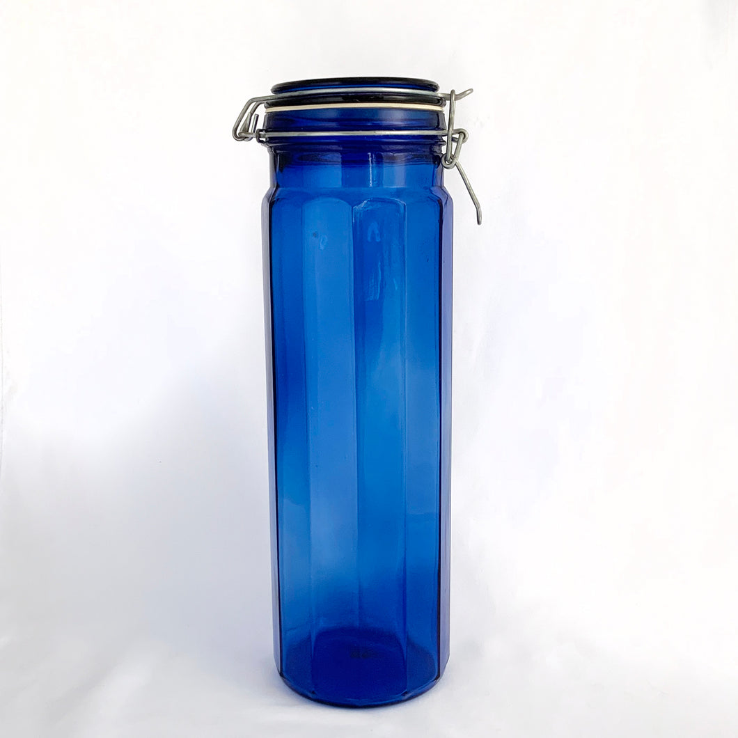 Vintage twelve panel cobalt blue glass apothecary storage jars with wire bail lids.  In excellent condition, free from chips/cracks.  Measuring:  3 7/8 x 13 inches  3 7/8 x 9 3/4 inches  3 7/8 x 8 inches