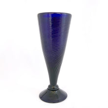 Load image into Gallery viewer, Vintage hand blown cobalt blue footed bud vase with ribbed/swirl pattern. Perfect for a pretty bouquet, or repurpose to hold make-up brushes.  In excellent condition. Pontil scar. Maker unknown.  Measures 3 x 7 1/2 inches
