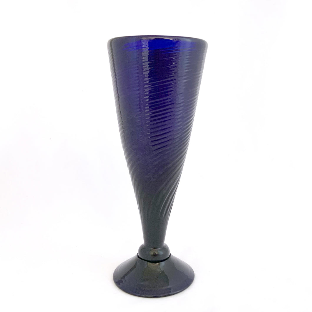 Vintage hand blown cobalt blue footed bud vase with ribbed/swirl pattern. Perfect for a pretty bouquet, or repurpose to hold make-up brushes.  In excellent condition. Pontil scar. Maker unknown.  Measures 3 x 7 1/2 inches