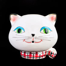 Load image into Gallery viewer, Adorable vintage mid-century kitschy Cozy Kitten wall mounted string and scissor holder. This ceramic white cat holds a ball of string which can be threaded through the mouth along with a pink, black and white checked collar with bow for holding scissors. Produced by Holt Howard, Japan, 1958.  In vintage condition, no chips. Although there are two cracks on this piece, it will still look great mounted on the wall or sitting on a shelf to complement your kitsch decor.  Measures 5 x 4 inches
