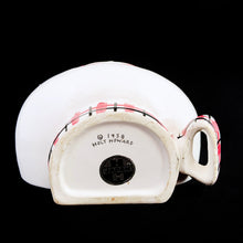 Load image into Gallery viewer, Adorable vintage mid-century kitschy Cozy Kitten wall mounted string and scissor holder. This ceramic white cat holds a ball of string which can be threaded through the mouth along with a pink, black and white checked collar with bow for holding scissors. Produced by Holt Howard, Japan, 1958.  In vintage condition, no chips. Although there are two cracks on this piece, it will still look great mounted on the wall or sitting on a shelf to complement your kitsch decor.  Measures 5 x 4 inches
