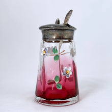 Load image into Gallery viewer, Antique cranberry glass silver lidded condiment jar, hand painted with enamel flowers. Maker unknown. Sterling silver ladle or spoon made in Birmingham England.   The jar is in good vintage condition. Glass is free from chips/cracks and the lid has an aged patina. The spoon is in excellent condition, in as found condition.  Jar measures 1 7/8 x 3 1/2 inches  Spoon measures 3-1/2&quot;
