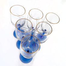 Load image into Gallery viewer, A delightful set of six vintage &quot;Crystal Blue&quot; stemmed wine glasses with a drape detail on the clear bowl, cobalt blue stem and gold trim. Produced by the Libbey Glass Company, USA, circa 1980s. These were produced as a promotional Christmas items for Arby&#39;s Restaurants.  In excellent condition, free from chips/cracks.  Measures 3 x 8 inches

