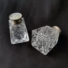 Load image into Gallery viewer, A vintage set of two traditional cut crystal pyramid shaped salt and pepper shakers in the art deco style with sterling silver and mother of pearl lids.   In excellent condition, no chips or cracks. Marked BIRKS STERLING on the lid.  Measures 1-1/4&quot; x 1-3/4&quot;
