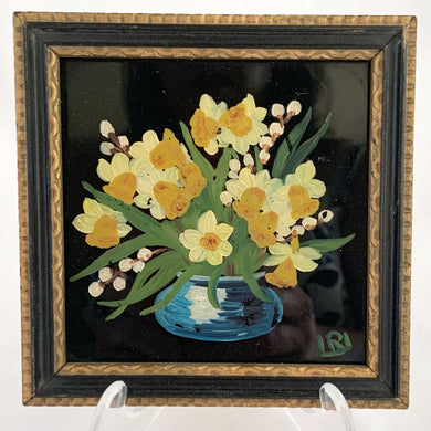 A signed still life oil painting on glass. This piece depicts a blue vase filled with white daffodil with yellow centres. It is signed by hand in the lower right corner with 