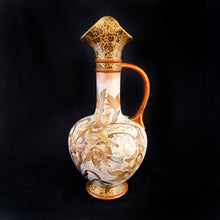 Load image into Gallery viewer, Stunning antique porcelain ewer or pitcher with hand painted daffodils (narcissus) in earthtones, purple and yellow lilies, gold on deep burgundy floral transferware decorate the top and foot. Produced by Royal Doulton, Burslem England. This piece dates between 1886 - 1902. A lovely piece to add to your decor!  In used condition, with a repair one side of the pouring lip. Otherwise no issues. Stamped Royal Doulton mark and impressed with 8566 BURSLEM and painted mark A.2941.  Measures 4 x 9 3/4 inches
