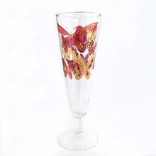 Load image into Gallery viewer, Sip a cold beer or bubbly champagne in style with these stunning vintage pilsner glasses decorated with bright gold and deep pink butterflies. Maker unknown. Circa 1960s.  In excellent condition, free from chips/cracks/wear.  Measures 8.5&quot; tall
