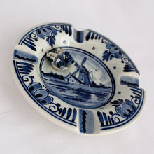 Load image into Gallery viewer, Small hand painted vintage ceramic ashtray, hand painted with traditional Danish scenes of windmills with figural clogs attached. Produced by Delft, Holland.  In excellent condition, free from chips/cracks.  Measures 3-3/4&quot;
