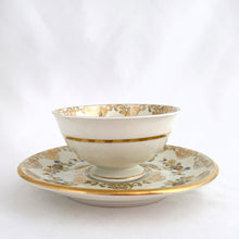 Load image into Gallery viewer, Vintage white porcelain demitasse cup and saucer beautifully decorated with colourful flowers and gold gilt details. Produced by Artibus of Portugal, circa 1940 - 1980.  In excellent condition, free from chips/cracks.  Dimensions of cup 3-1/8&quot; x 1-5/8&quot; | saucer 4-3/4&quot;
