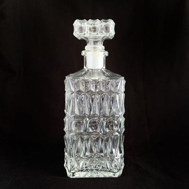 Vintage clear pressed glass liquor decanter with a diamond and dot pattern with square dot pattern stopper. Stopper has a plastic insert for a tight seal. A fabulous addition to your bar cart! This would even be a great decanter for fruit juices for your brunch buffet.  Excellent condition, no chips or cracks.  Measures 3 3/8 x 8 7/8 inches