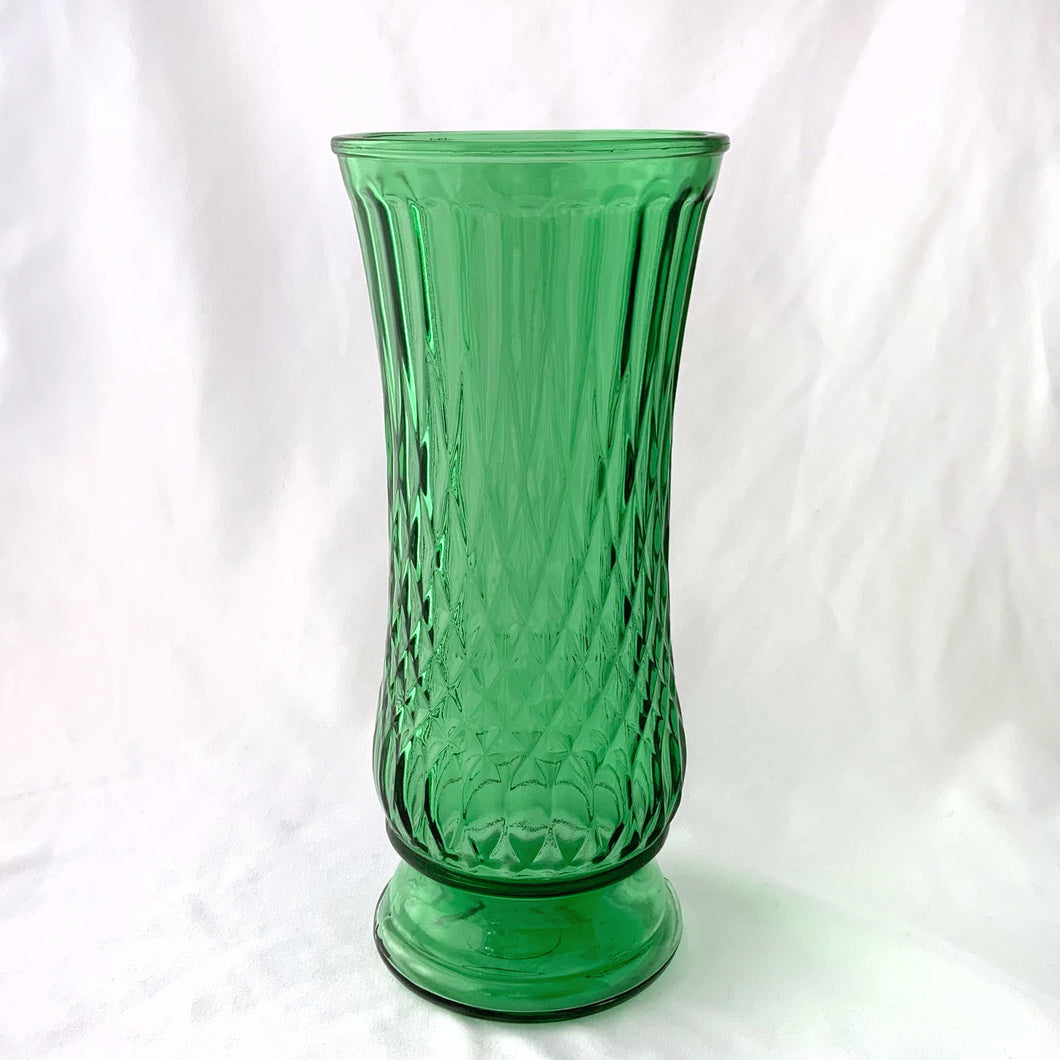 A lovely green glass vase with an impressed diamond pattern. Fill this vessel with a generous sized bouquet of flowers!  In excellent condition, no chips or cracks.  Measures 4 5/8 x 10 1/4 inches