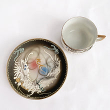 Load image into Gallery viewer, Vintage slip-glazed moriage, hand painted Dragonware espresso or child&#39;s porcelain cup and saucer with gold detail on the handle and rim. Marked &quot;HAND PAINTED BETSONS, circa 1950. The artistry of this piece is stunning!  In excellent condition, free from chips/cracks.  Cup measures 2&quot; x 1-1/2&quot; and saucer measures 3-3/4&quot;
