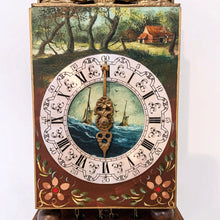 Load image into Gallery viewer, Vintage folklore wood wall clock with brass scrollwork, brass Atlas holding a black globe above its head, decorated with the moon and stars. The clock dial has with roman numerals, numbers and decorative elements in black with central hand painted scene of the sea with two sailing ships, above the dial is a pastoral scene and below folk art florals. Eight day movement with chime striking on the hour and every half hour. Brass weights, pendulum and chains included. Warmink WUBA, Netherlands, circa 1960s.
