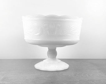 A beautiful vintage milk glass footed compote. Produced by the E.O. Brody Glass Co., USA, circa 1960. Perfect to use a fruit bowl, catchall or planter.  In excellent condition, free from chips/cracks.   Measures 6 3/4 x 5 1/2 inches