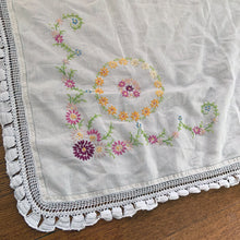 Load image into Gallery viewer, Lovely vintage ecru/off-white square linen tablecloth. Each corner of the tablecloth is  hand embroidered with a colourful floral motif in shades of pink, yellow, blue, purple and green and the perimeter has an intricate white crochet border. Use as intended or repurpose the border or embroidery in other projects.  In great vintage condition, free from tears or stains.  Measures 38-1/2&quot; x 38-1/2&quot;
