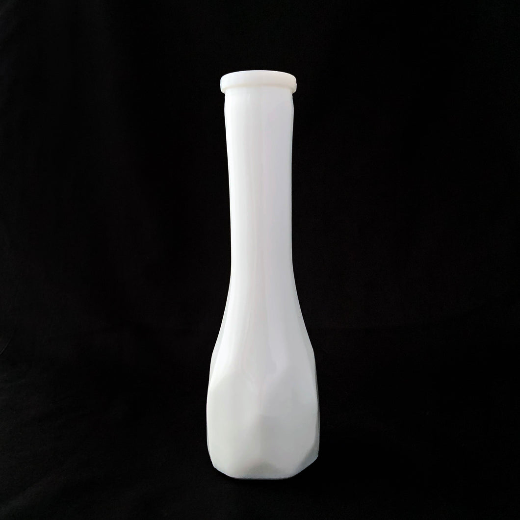 Vintage white milk glass floral bud vase with a elongated hexagon paneled pattern. Produced by the E.O. Brody Glass Company, circa 1960s. This elegant vase is perfect for wedding, bridal arrangements and suits any decor style.

In excellent condition, no chips/cracks.

Measures 2 5/8 x 8 1/2 inches