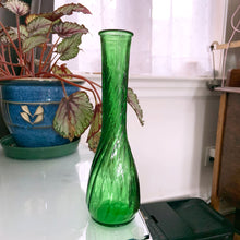 Load image into Gallery viewer, A very popular piece, this vintage emerald green pressed glass 9&quot; bud vase with swirled body and flat edge. Any flower arrangement looks beautiful in this simple, yet elegant vase. A perfect addition to any home decor style, in particular shabby chic or farmhouse. Make a lovely piece to include in wedding or bridal shower decor.  In excellent condition, no chips or cracks.  Measures 2-1/2&quot; x 9&quot;
