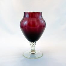 Load image into Gallery viewer, This petite amethyst art glass goblet produced in the Empoli Region of Italy, features a lovely swirled detail in the glass bowl in a stunning deep amethyst colour. The clear twisted stem adds a lovely finishing touch to this goblet. This is a great mid-century modern piece of art glass to add to your decor collection. Dates between 1950 to 1970 and was likely imported by Giftcraft of Toronto.  In excellent  condition, no chips or cracks.  Measures 3 3/4 x  6 1/4 inches
