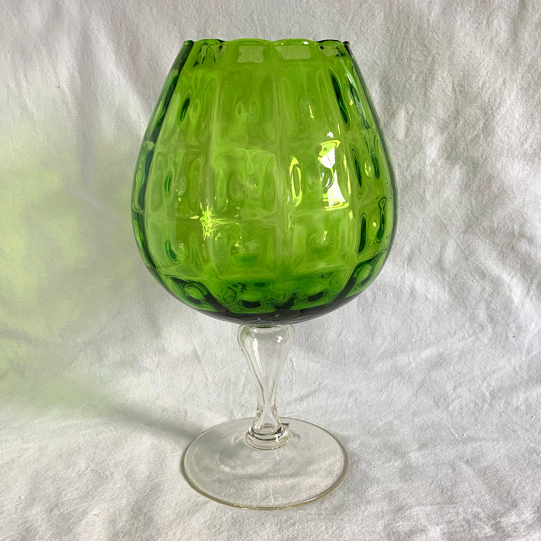 Vintage mid-century hand blown optic art glass snifter features a funky pattern of squares and circles in striking emerald green with a clear stem. Crafted in the Empoli Region of Italy 1950 - 1970, imported by Giftcraft to Canada. The perfect compliment to enhance your MCM decor.

In excellent vintage condition, no chips or cracks. Original sticker.

Measures 8 1/2 x 15 inches