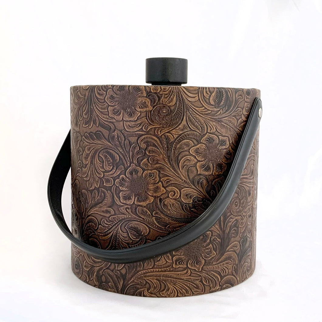 Vintage faux tooled leather ice bucket with floral paisley pattern in brown with black lid and handle. Hammered metal claw tongs included. Produced by Irvinware USA, circa 1970.  In excellent condition, free from wear/damage.  Measures 7-3/4