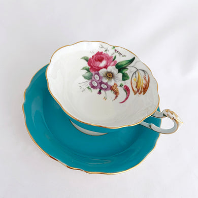 Vintage colourful floral bouquet, turquoise exterior with gold trim bone china teacup and saucer. Produced by Paragon, England, circa 1940. A beautiful set to add to your collection or give as a gift. In excellent condition, free from chips, cracks and repairs. Teacup measures 4 x 2 1/8 inches | Saucer measures 5 1/2 inches