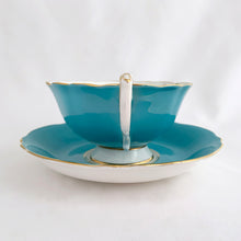 Load image into Gallery viewer, Vintage colourful floral bouquet, turquoise exterior with gold trim bone china teacup and saucer. Produced by Paragon, England, circa 1940. A beautiful set to add to your collection or give as a gift. In excellent condition, free from chips, cracks and repairs. Teacup measures 4 x 2 1/8 inches | Saucer measures 5 1/2 inches
