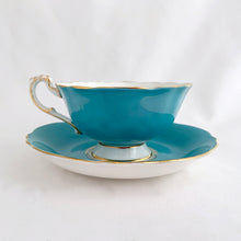 Load image into Gallery viewer, Vintage colourful floral bouquet, blue exterior with gold trim bone china teacup and saucer. Produced by Paragon, England, circa 1940.  In good condition, free from chips, cracks and repairs.  Teacup measures 4 x 2 1/8 inches  | Saucer measures 5 1/2 inches

