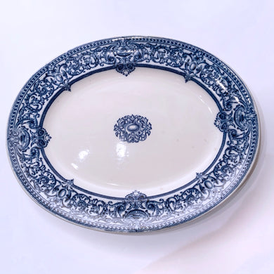 Classic flo blue and white ironstone platter. A gorgeous piece of transferware produced by Doulton in Burslem England, circa 1930s. This large serving platter will be the star of family meal, displays well in a china cabinet or could be used as wall art.  In good vintage condition, minor chip to the edge, but it may be a manufacturer's defect. Flat bottom has normal wear. Marked.  Measures 15 3/8 x 12 1/2 inches