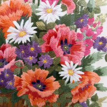 Load image into Gallery viewer, This is a stunning hand embroidered crewel of a colourful bouquet of flowers in a basket. A large piece which would have taken many hours to stitch and the craftsperson did an excellent job on this very detailed embroidery. One of the most beautiful pieces we&#39;ve found in the wild! Professionally stretched, matted and framed in wood (with glass).  In excellent condition.  Embroidered area measures approximately 13&quot; x 19&quot;, frame measures 21&quot; x 27&quot;
