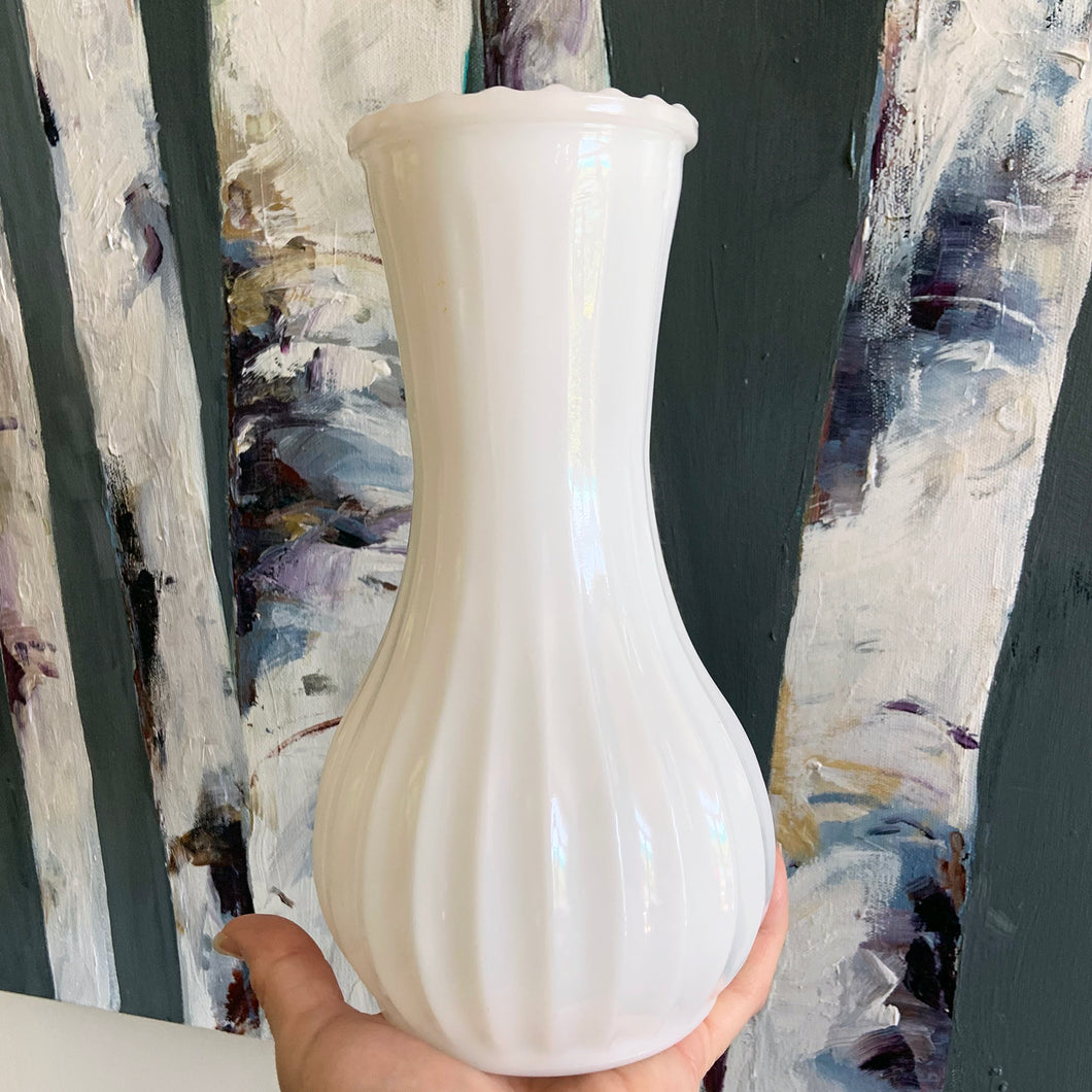 A very popular piece, this vintage milkglass bud vase with fluted body and sawtooth mouth was made by CLC Co. Any flower arrangement looks beautiful in this simple, yet elegant vase. A perfect addition to vintage home, farmhouse or wedding decor.  In excellent condition, no chips or cracks.  Measures 4 1/2 x 9 inches