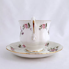Load image into Gallery viewer, Vintage teacup and saucer in the &quot;Fragrance&quot; pattern. Produced by Paragon Fine Bone China England.  In excellent condition, free from chips/cracks/repairs. Maker&#39;s marks on the bottom with Royal Warrant and &quot;BY APPOINTMENT TO HER MAJESTY THE QUEEN&quot;  Dimensions of cup 2-3/4&quot; x 2-1/2&quot; and saucer 4-5/8&quot;
