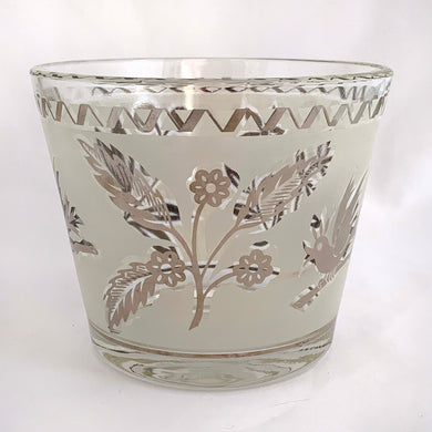 A super cool piece of mid-century history in this hollywood regency style ice bucket with silver birds and botanicals on a frosted band and silver ric rac detail at the rim. Produced by the Libbey Glass Company, USA, circa 1960s.  In excellent condition, no chips, cracks and the silver is in great condition.  Measures 4 3/4 x 5 3/4 inches