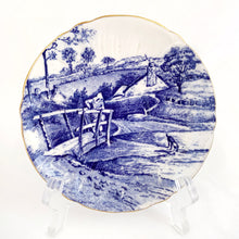 Load image into Gallery viewer, A rare vintage &quot;Glorius Devon&quot; cup and saucer. Just love the pretty blue pastoral landscape on white with scalloped shape and gold trim. Produced by Shelley in England, between 1940 - 1966.  Marked on the bottom with backstamp and the number &quot;12734&quot;.  Cup 3 x 1 7/8 inches  Saucer 4 5/8 inches
