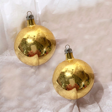 A pair of classic hand blown vintage gold glass ball Christmas tree ornaments with great patina.  In vintage condition.  Each measures 2