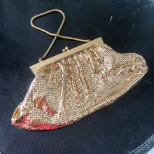 Load image into Gallery viewer, Gorgeous vintage art deco style gold toned metal mesh evening bag, lined with peachy-clay coloured fabric with pocket, kiss closure and serpentine chain handle. Designed by Whiting and Davis, made in the USA. A great period piece that would make an fabulous accessory!  Measurements: Width: 9-1/2&quot; Height: 5&quot;  In overall excellent vintage condition. Some marks to the frame. Lining is intact and  a couple of stitches need reinforcement to the loops. Please review photos.
