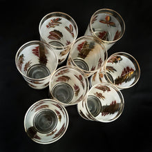 Load image into Gallery viewer, Set of eight mid-century vintage Golden Foliage highball glasses in brass carrying caddy with spiral handle.  Produced by the Libbey Glass Company between 1953 - 1978. These glasses will elevate any bar cart and are perfect for any occasion or cocktail! Great vintage condition. The glasses are free from chips/cracks. Minor wear present to the gold on the rim. Each glass measures 2-3/4&quot; x 5-1/2&quot; (12oz)
