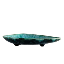 Load image into Gallery viewer, Vintage green drip glaze footed redware pottery dish in an atomic triangular shape. Produced by Blue Mountain Pottery, circa 1970s. Perfect as a decor piece, a candy/nut dish or a catchall.  In excellent condition, free from chips/cracks.  Measures 7 1/2 x 11 1/2 inches
