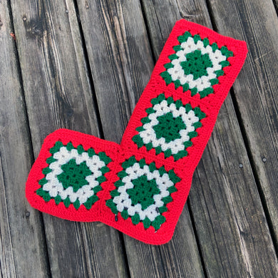 Sweet vintage handmade crocheted granny squares Christmas stocking with green and white squares banded with red. Such a lovely piece to hang on your mantle and fill with treats.  In excellent condition.  Measures approximately 12