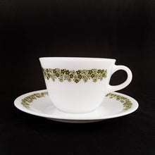 Load image into Gallery viewer, Vintage cup and saucer in the green &quot;Spring Blossom&quot; pattern on white glass. Microwave safe. Produced by Corning USA, circa 1970.  In excellent condition, free from chips/cracks/wear.  Cup measures 3-3/4&quot; x 2-3/4&quot; and the saucer measures 6-3/16&quot;
