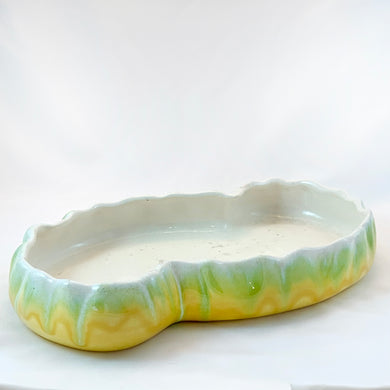 Sweet vintage drip glazed console bowl in yellow, green and creamy white. The colours are vibrant and meld together so nicely and really make the shape of this piece pop. Produced by Haeger Pottery, USA, circa 1950s. Perfect to use as an Ikebana vessel or for the bonsai hobbyist. Easily repurposed as a catchall or even giant snack dish.  In excellent condition, no chips or cracks. Measures 12 x 7  x 1 3/4 inches