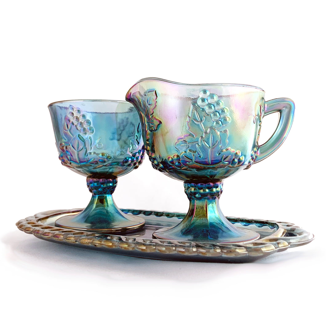 Vintage blue carnival glass creamer, sugar and tray set in the  