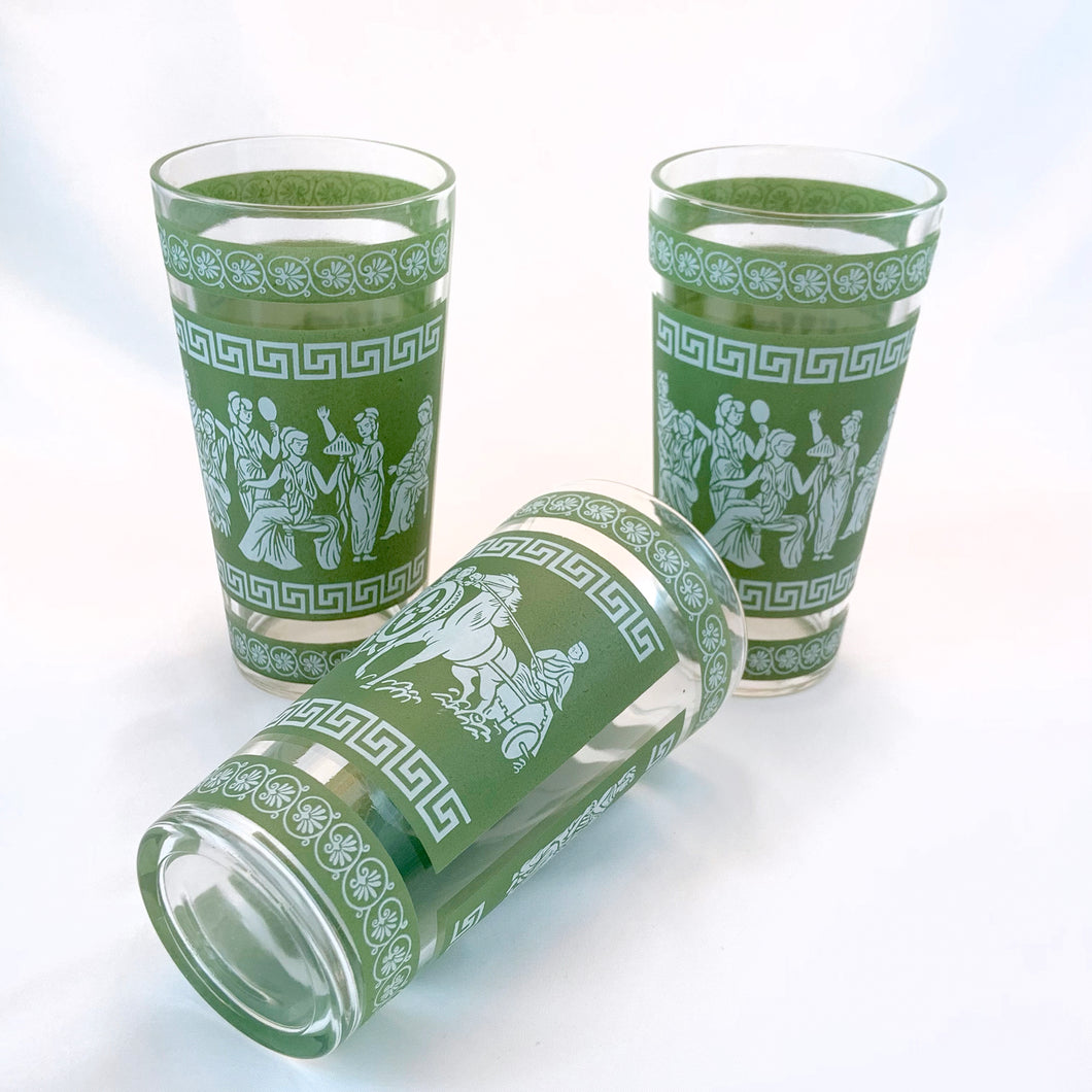 Vintage mid-century green and white Hellenic highball glasses feature a Jasperware-like design featuring a motif of toga-wearing figures, horses, chariots, topped with Greek key and palm leaves. Crafted by Jeannette Glass, USA, 1960s. These glasses were literally is everyone's rec rooms back in the day!

Measures 3 x 5 3/4 inches

Capacity 9 ounces
