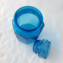 Load image into Gallery viewer, This vintage sky blue apothecary jar is perfect to store dry goods, bath accessories or as a beautiful display piece. Great hexagonal shape with a daisy on the top of the ground stopper. Takahashi Glass, Japan, circa 1970.  In excellent condition, no chips or cracks.  Measures 3 1/2 x 5 1/2 inches
