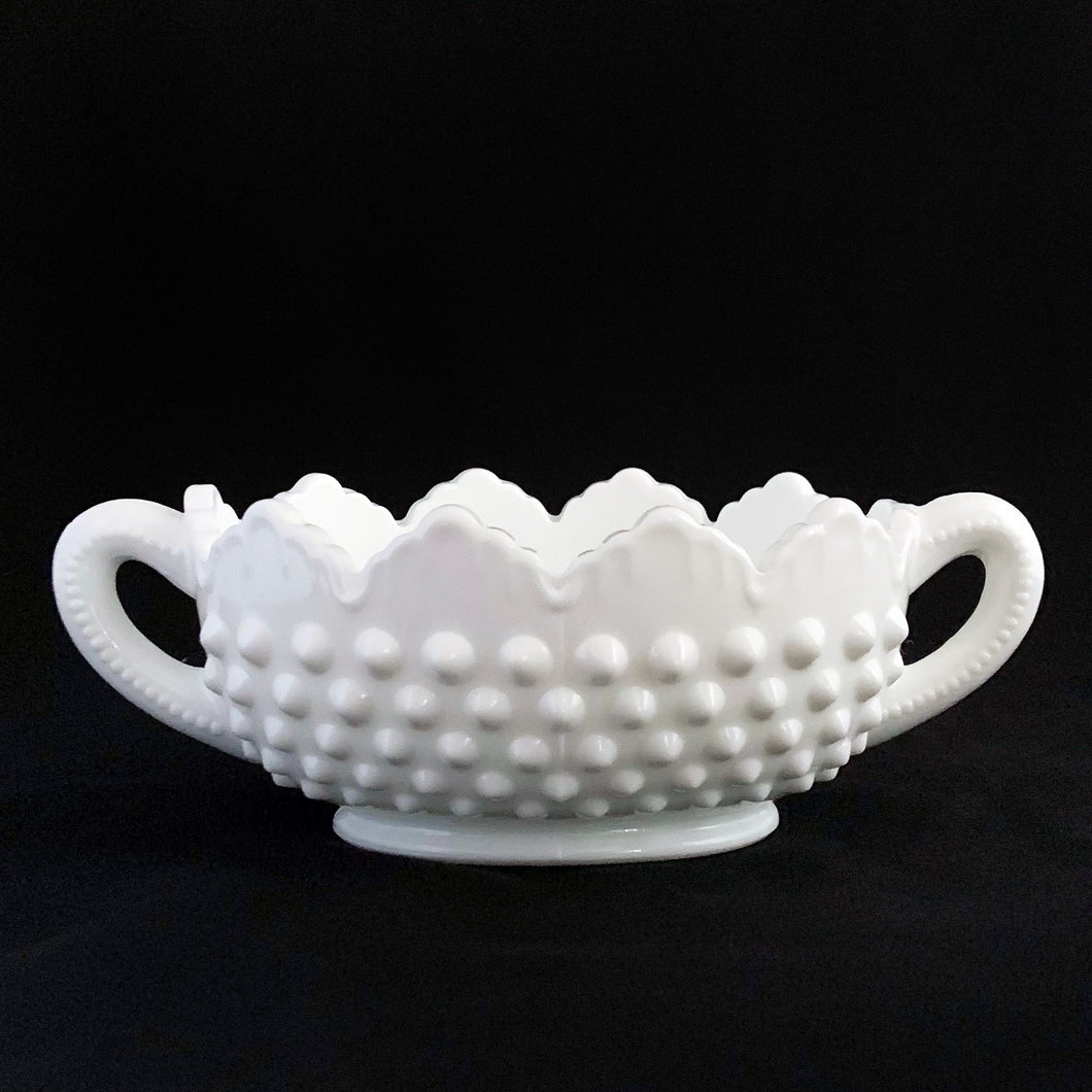 Vintage white milk glass is the epitome of simple elegance! This pretty piece is a handled nut dish in the 