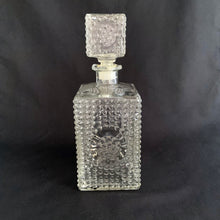 Load image into Gallery viewer, A vintage retro pressed glass liquor decanter with a hobnail pattern with circle on all sides with square hobnail stopper. Stopper has a plastic insert for a tight seal. A fabulous addition to your bar cart! This would even be a great decanter for fruit juices for your brunch buffet.  Excellent condition, no chips or cracks.  Measures 8&quot;
