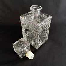 Load image into Gallery viewer, A vintage retro pressed glass liquor decanter with a hobnail pattern with circle on all sides with square hobnail stopper. Stopper has a plastic insert for a tight seal. A fabulous addition to your bar cart! This would even be a great decanter for fruit juices for your brunch buffet.  Excellent condition, no chips or cracks.  Measures 8&quot;
